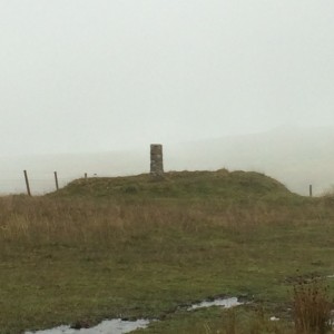 Emmetts Post set into a Bronze Age round barrow on Dartmoor